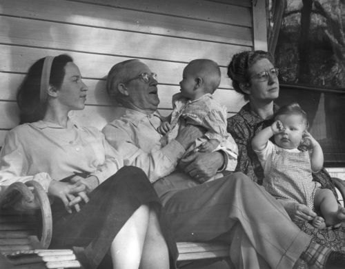 1951 Joyce, Dad, Deborah, Mom, Eric in porch swing